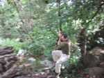 Bill swinging over the river on a vine